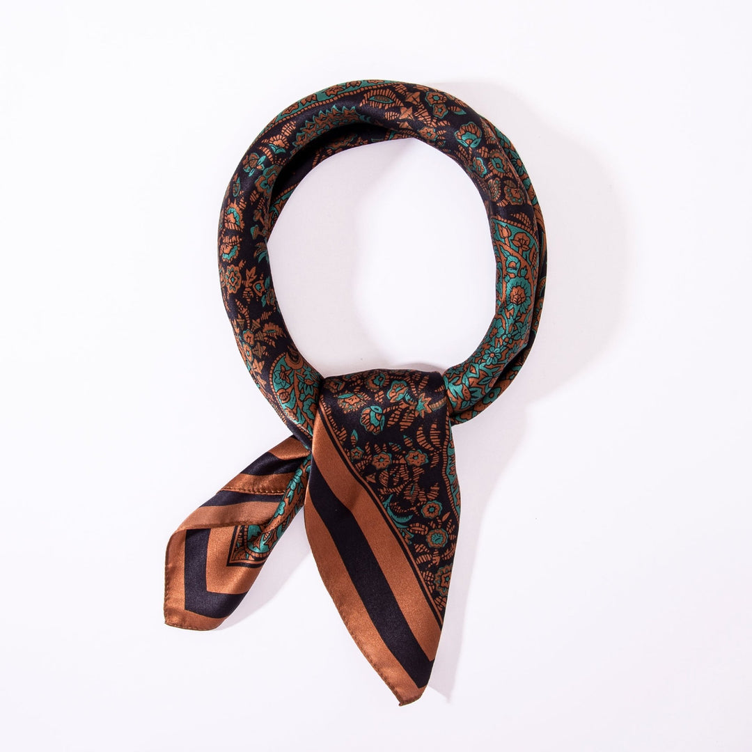 A Paisley Square Silk Scarf - Retro by SusanSilk, featuring a paisley pattern in shades of brown, green, and black, knotted and laid flat against a white background.