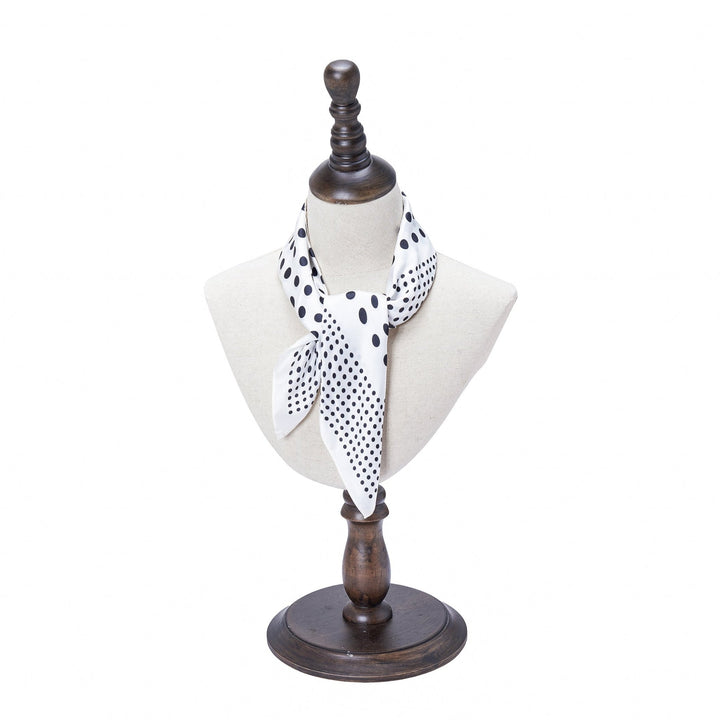 A Polka Dot Square Silk Scarf by SusanSilk is tied around the neck of a beige dress form on a wooden stand.